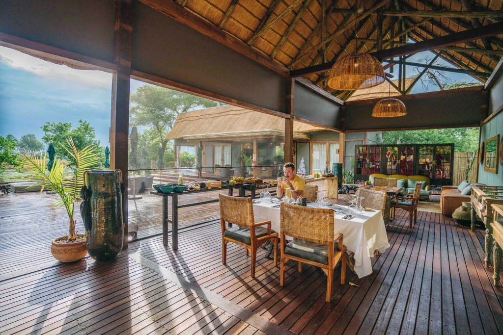 Actor Luke Evans enjoys a morning coffee while seated at an elegant breakfast setting at Atzaró Okavango.