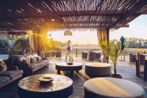 A couple walking in the lodge in Atzaró Okavango Camp 