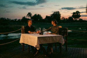 A couple enjoying the dining under the stars and Okavango sky.