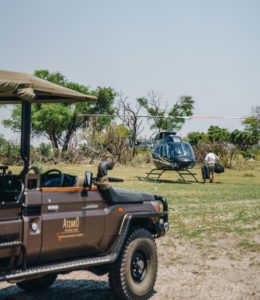Atzaró helicopter and safari vehicle in the Okavango Delta.