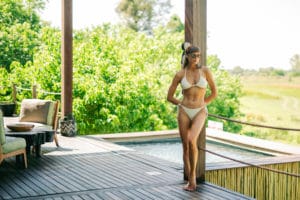 Woman in the pool lounge in Atzaró Okavango Camp.