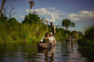 A couple enjoying the Mokoro Safari organized by Atzaró Okavango Camp.