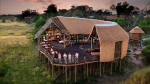 Guests relaxing in a luxury safari tent suite at Atzaró Okavango Camp, Okavango Delta, Botswana